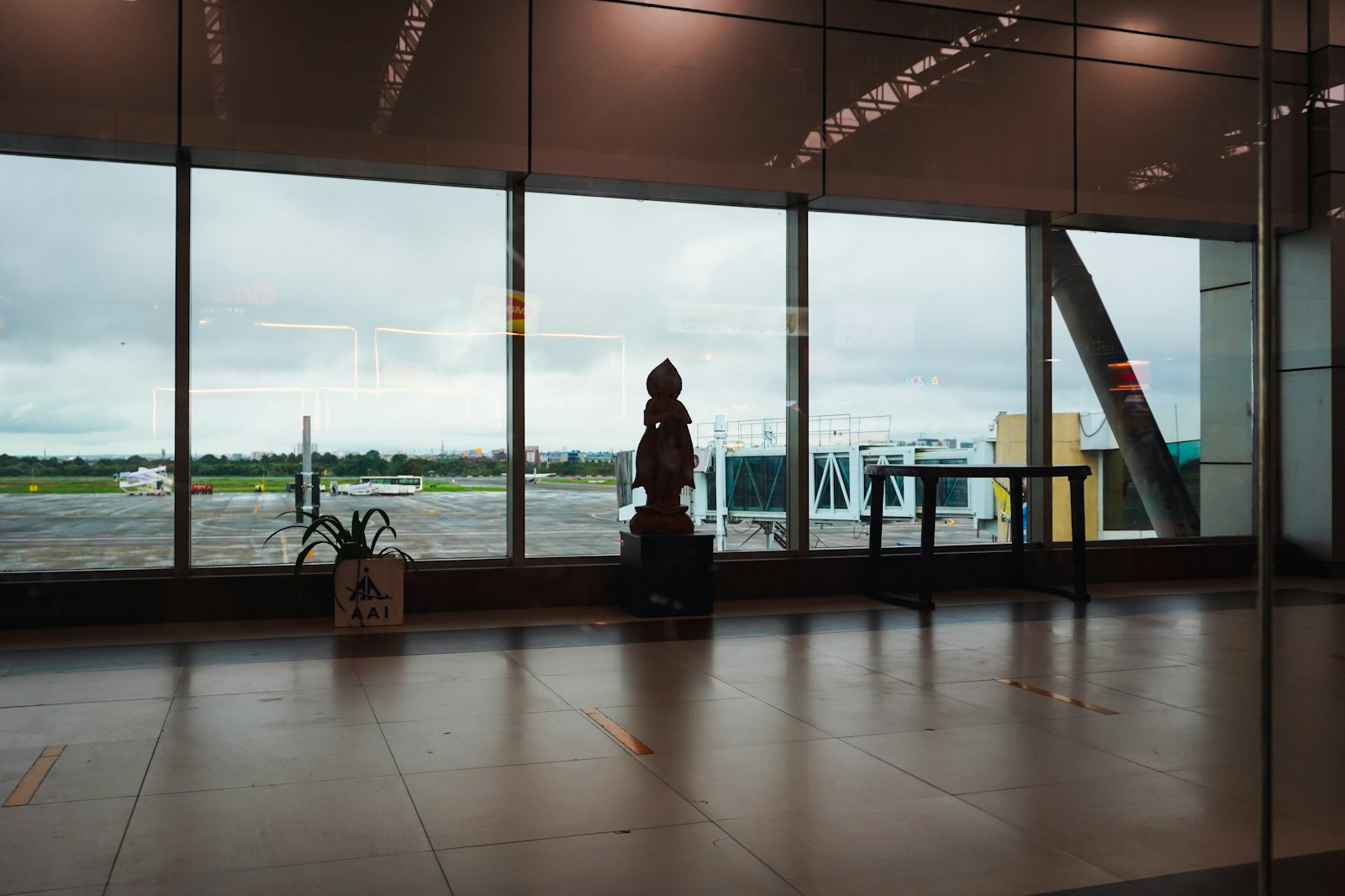 Airport lounge interior with aircraft visible through expansive windows